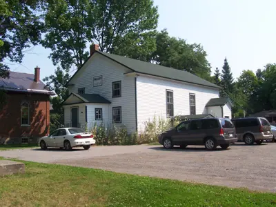 Prince Albert hall white building with cars in parking lot