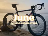 bike on shore at sunset with white text and yellow border overlaid saying 'June Scugog eNewsletter'