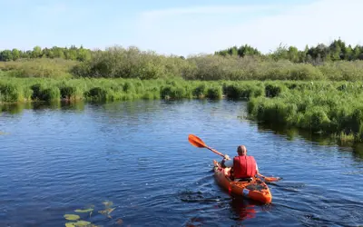 Man in kayak paddling lake