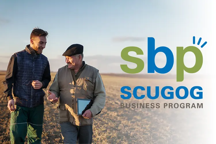 Two men in farm field with 'Scugog Business Program' logo on right side