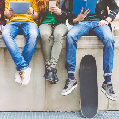 teenagers sitting on stair edge with skateboard