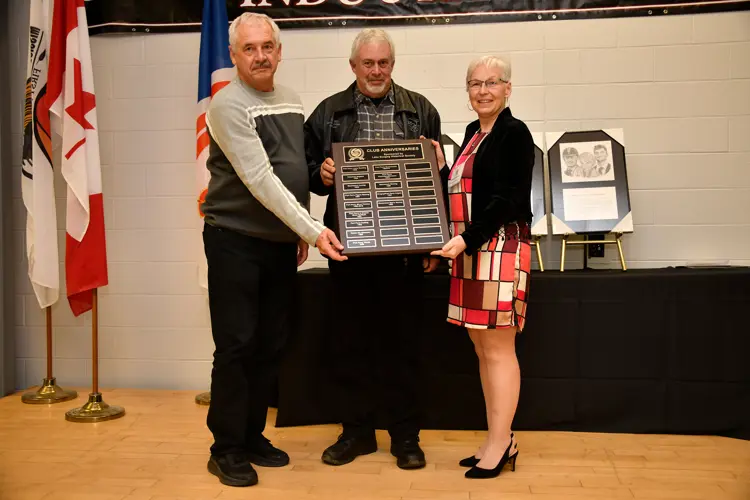 Hall of Fame chair presenting anniversary plaque