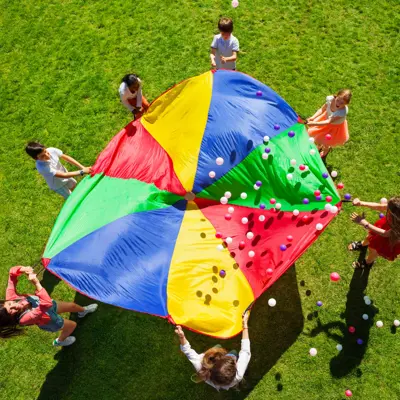 kids standing around a parachute